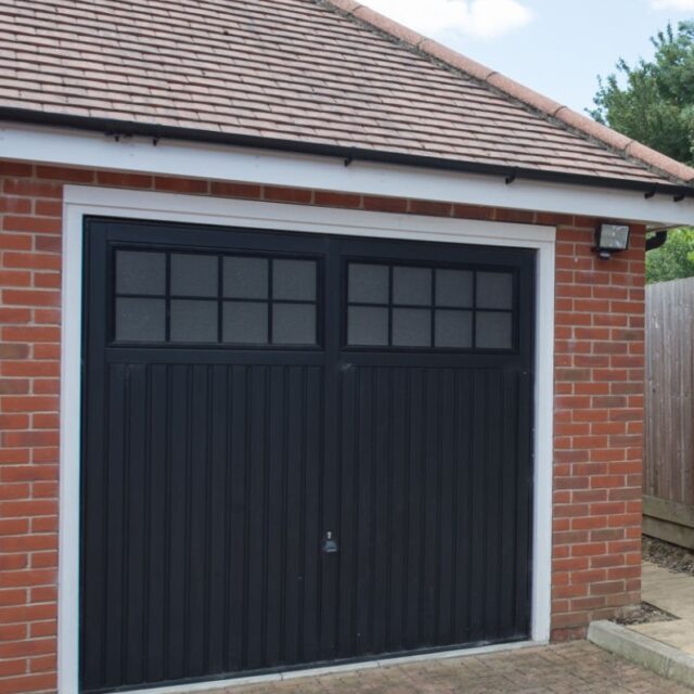 A general exterior view of an outside garage with black doors